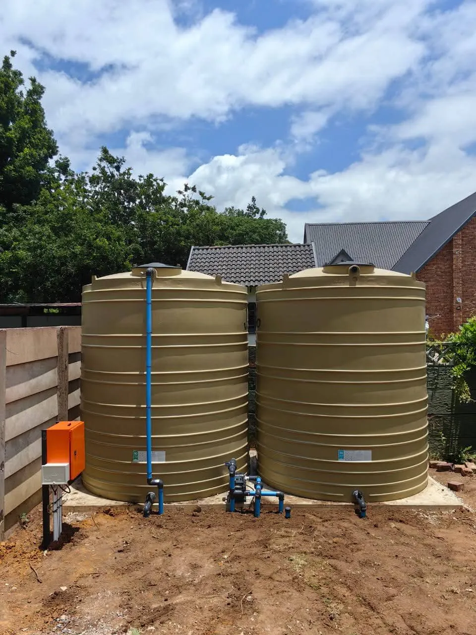 Twin storage tanks with booster pump